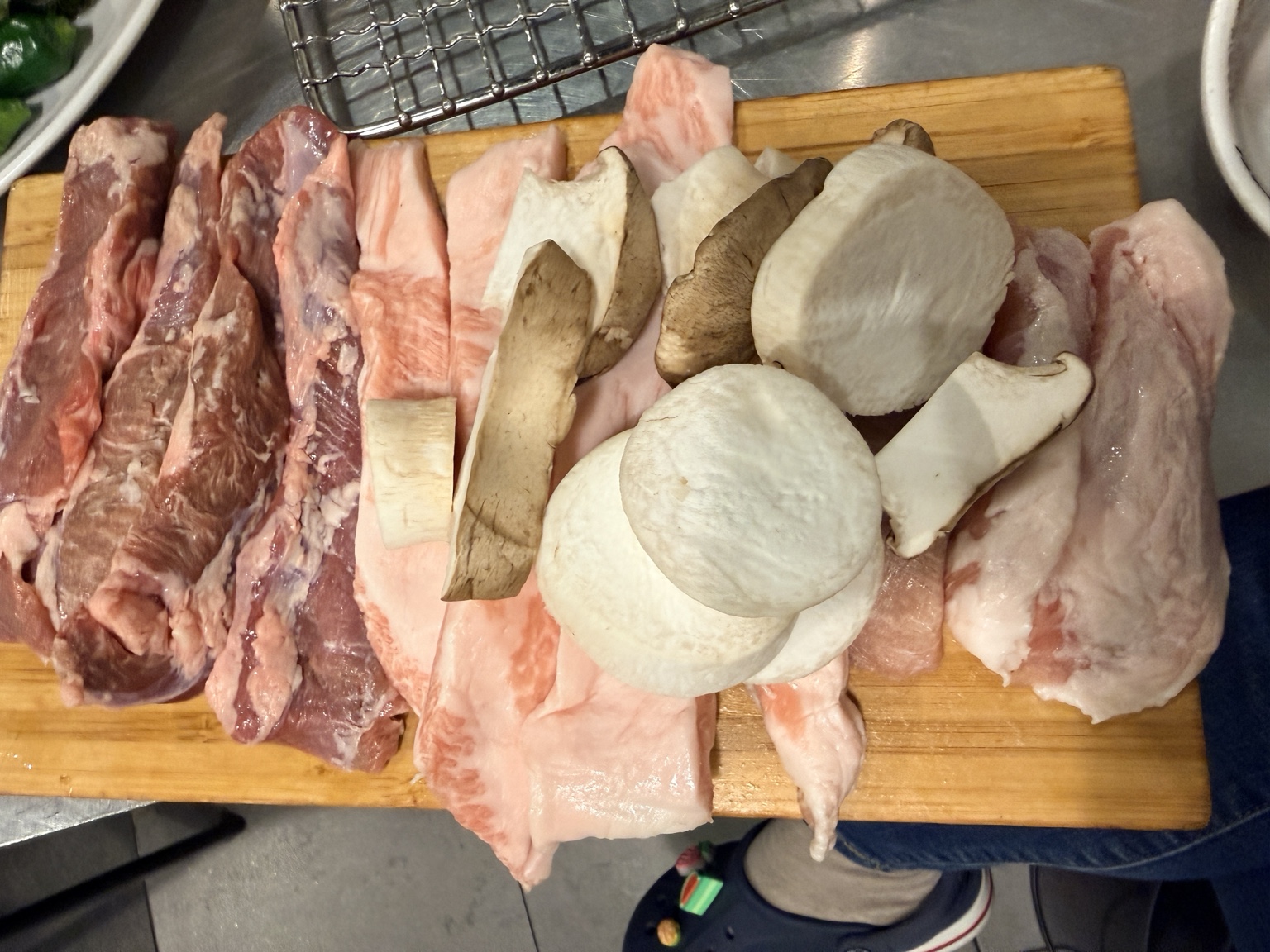 Thick raw hangjeongsal and galmaegisal pork cuts with mushrooms