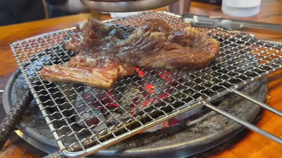 Pork galbi grilling over charcoal at Woori Charcoal Galbi in Sindang Seoul
